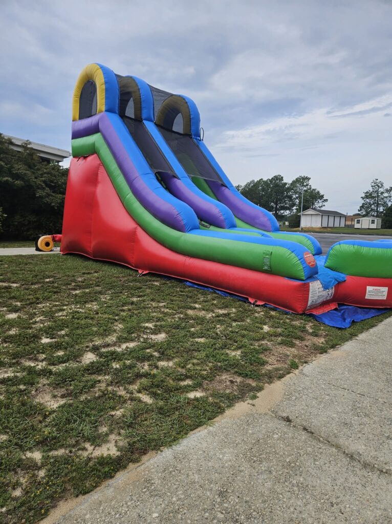 Rainbow 15 ft slide set up on a front lawn